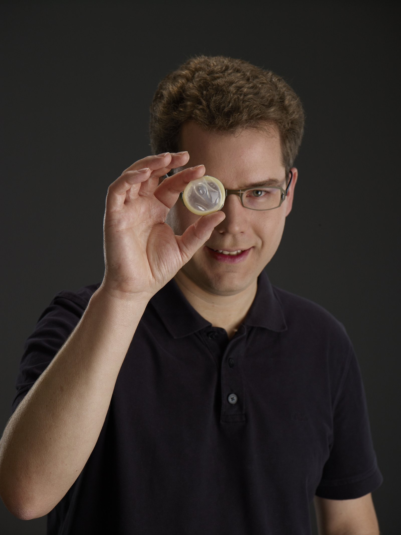 Jan Vinzenz Krause looks through a condom