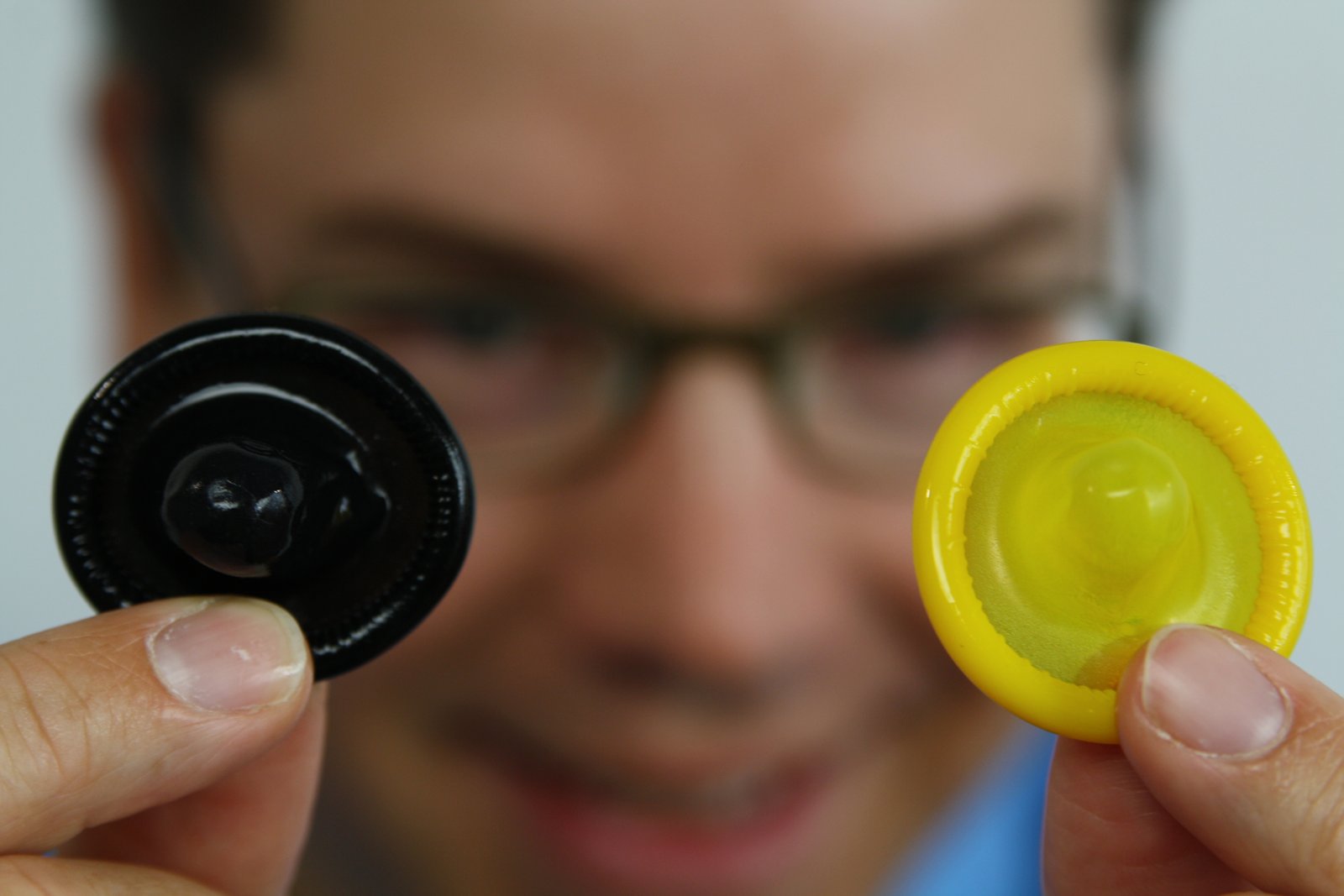 Jan Vinzenz Krause mit bunten Kondomen in gelb und schwarz